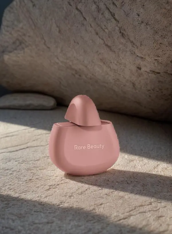 Pink perfume bottle animated on a sunlit white stone set
