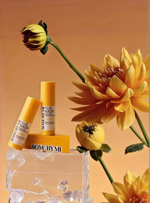 Yellow skincare collection floating among matching flowers
